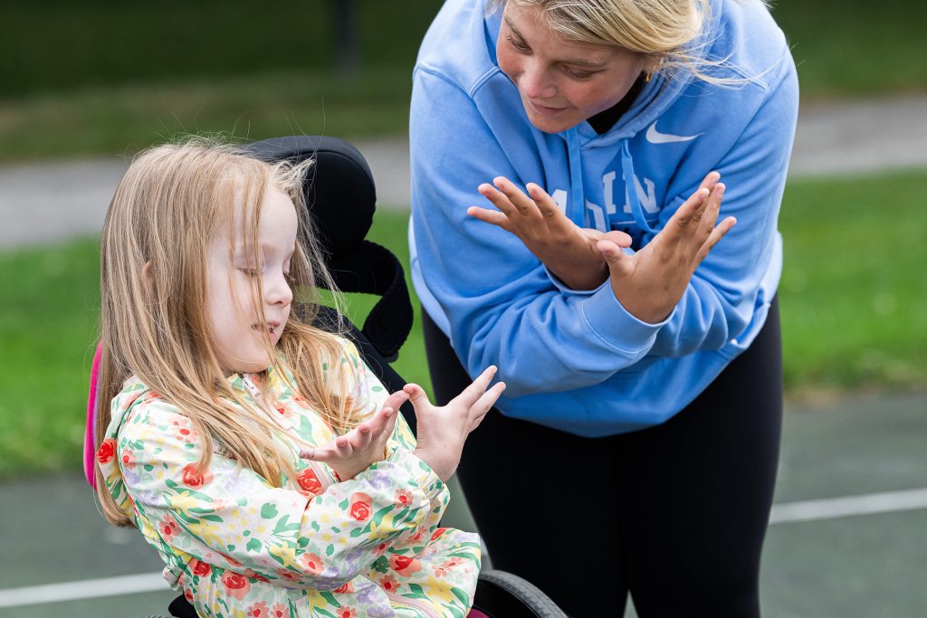 Youth Challenge - About us - Woman and girl doing motions with their hands