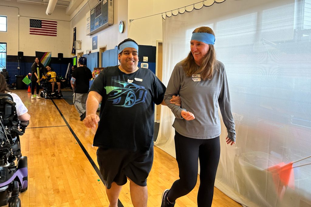 A man and a lady walking together, both wearing headbands