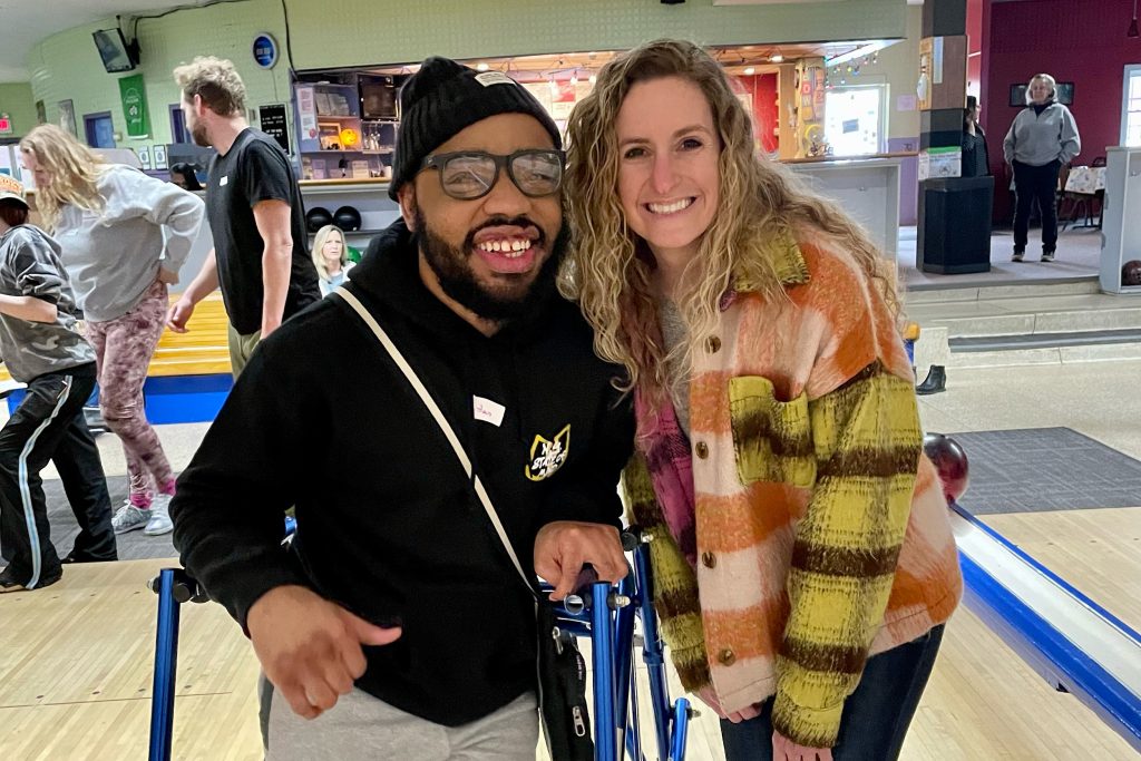 A man using crutches posing with a woman