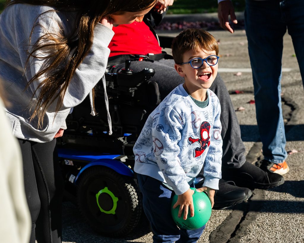Boy playing with a ball with a girl near him