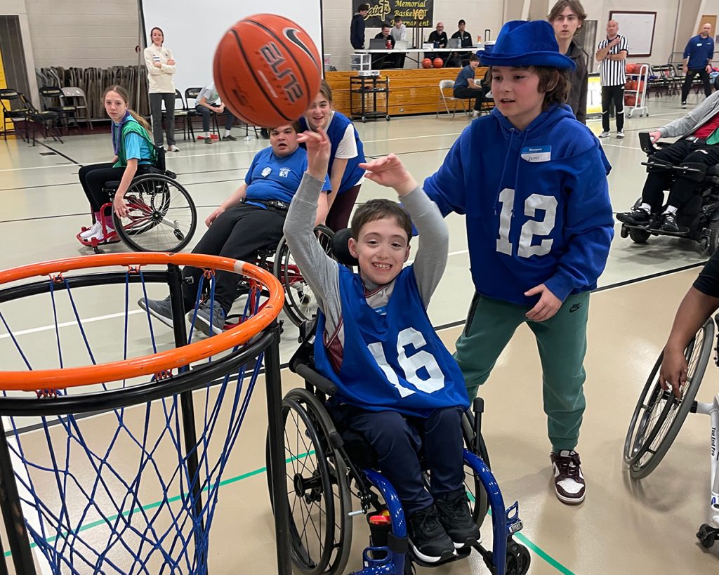 Kids in wheelchairs playing basketball