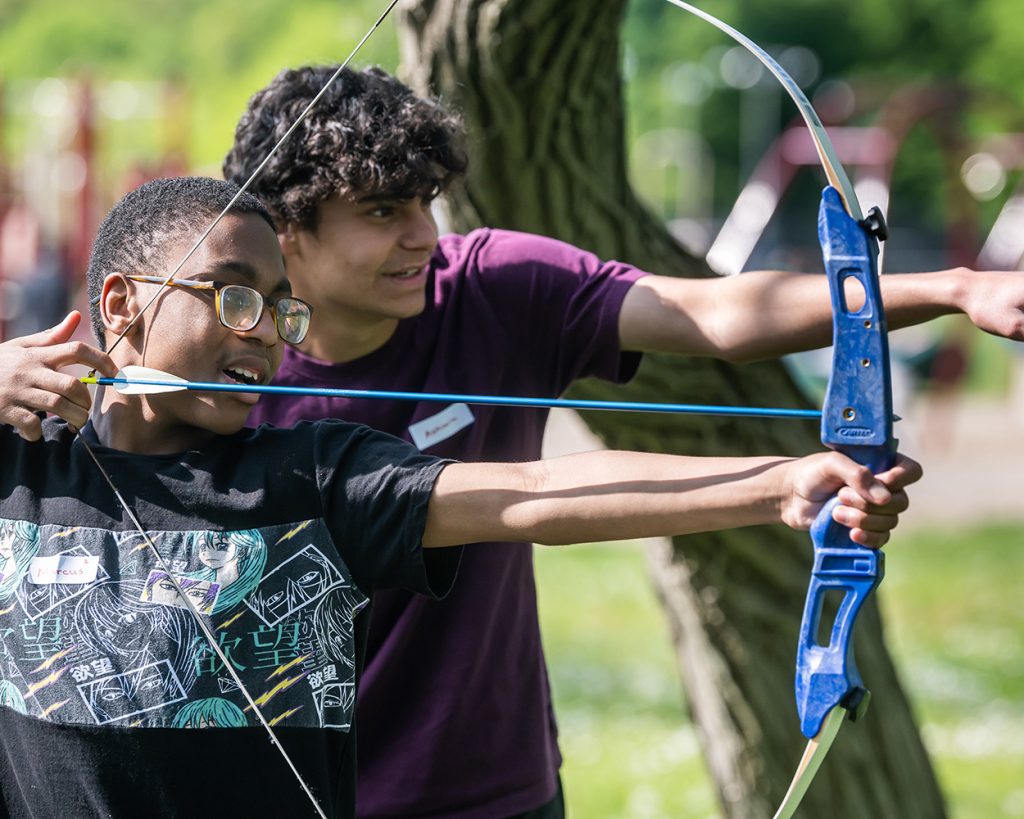 Boy and Teen using a bow and arrow