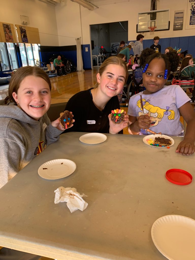 Three kids decorate cookies