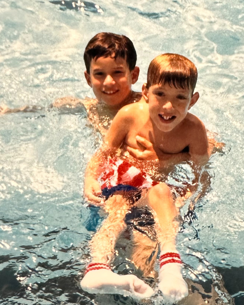 Two boys playing in a pool - vintage photo