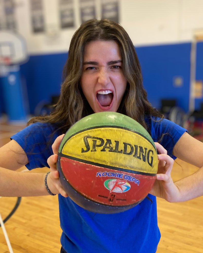 Maddy holding a basketball making a silly face