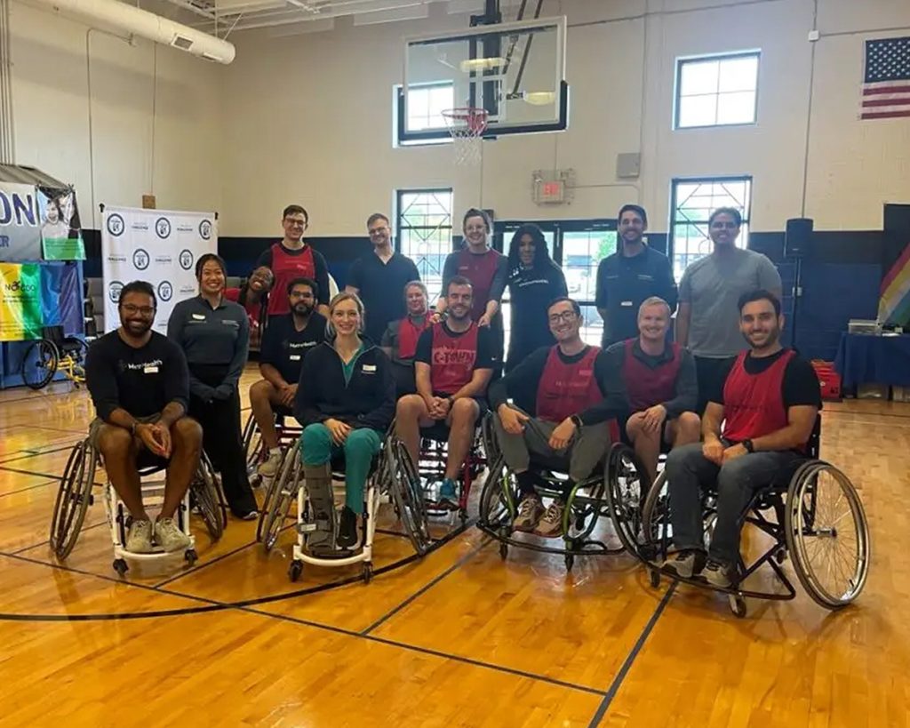 A group of people on a basketball court posing for a photo