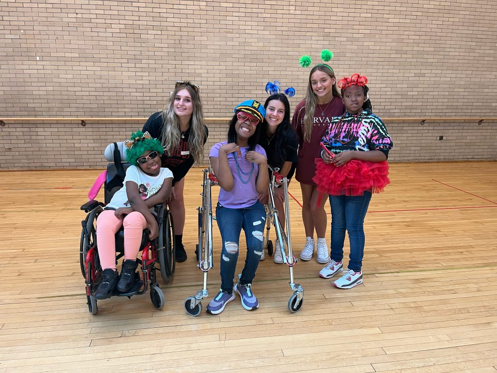 A group of girls wearing all sorts of silly clothing