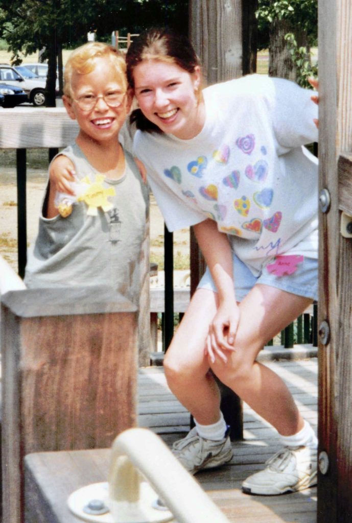 A young boy and girl stand next to each other smiling
