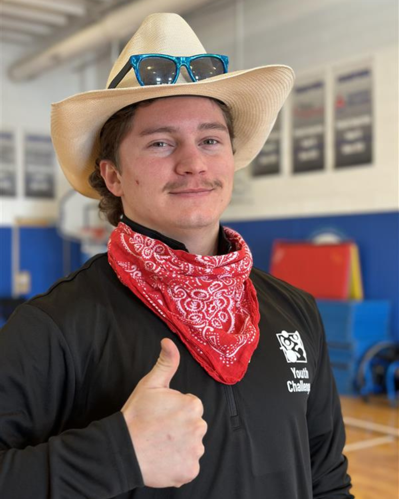 Stephen Faltay dressed as a cowboy giving a thumbs up.