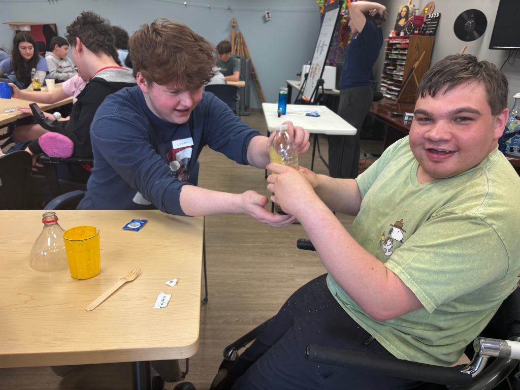 A male participant and his volunteer work on a science experiment