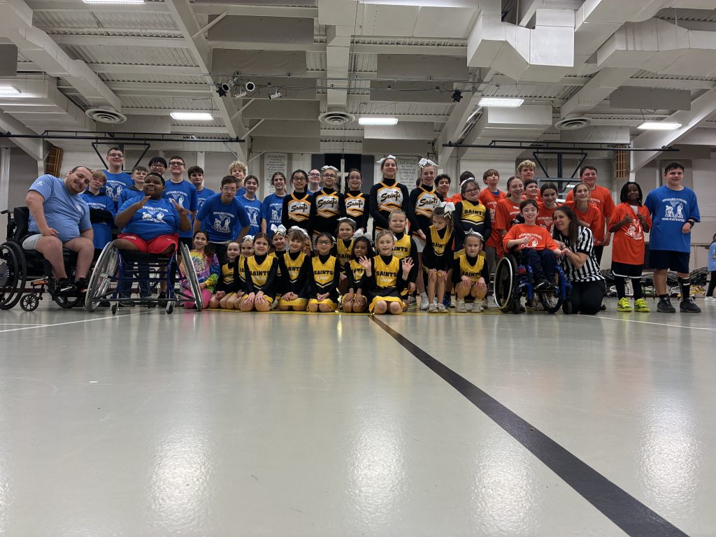 group picture of YC participants and volunteers and St. Peter School cheerleaders