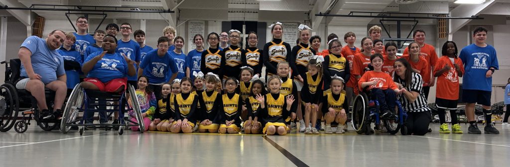 full group basketball showdown picture of participants, volunteers and St. Peter School students