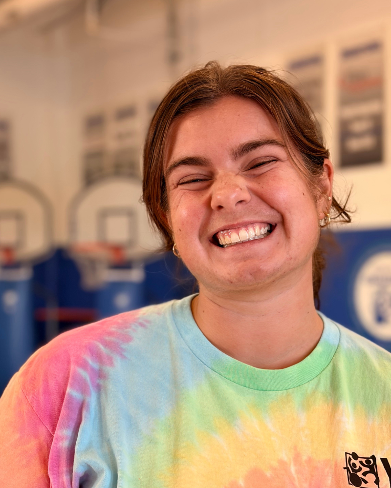 Gracie smiles in a tie dye YC t-shirt.